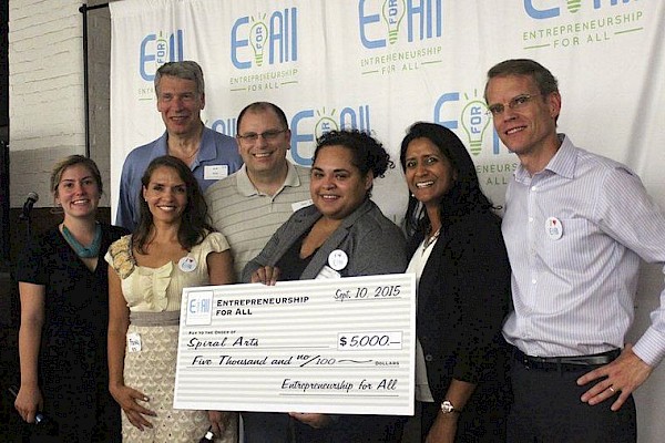 Courtesy photo Rosa Alemán, center with check, the grand prize winner of the Entrepreneurship for All Accelerator Program $5,000 prize, stands with, from left, EforAll program manager Mary Beth Burwood, mentor Bob Katz, EforAll Executive Director Franky Descoteaux, mentor Gary Chamberlin, keynote speaker Anita Worden, and EforAll CEO David Parker. via Eagle Tribune